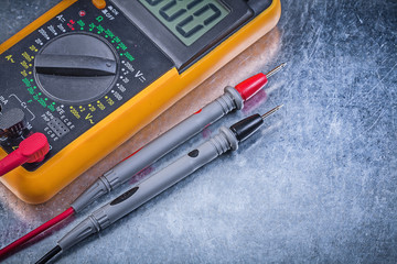 Digital electric tester on metallic surface horizontal view elec