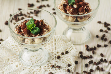 Tiramisu dessert in a glass with mint