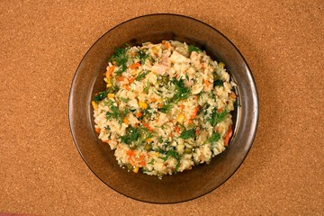 rice pilaf with peas and corn in a plate on the table