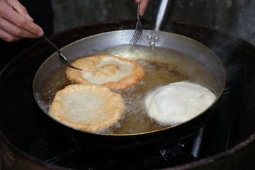 three pancakes in hot oil