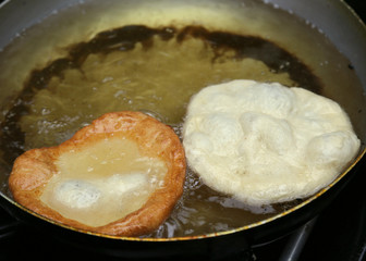 two sweet pastry fried in hot oil