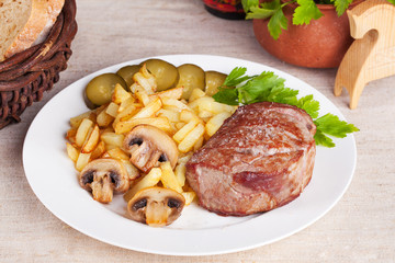 meat with french fries and pickles