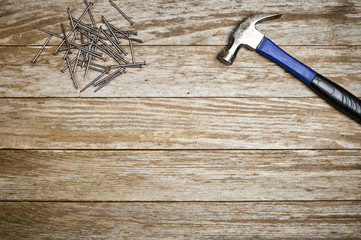 a hammer and nails on a wooden table