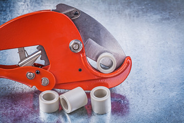 Pipe cutter water tube on metallic background construction conce