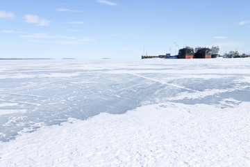 Old frozen cargo ships in the port at winter time