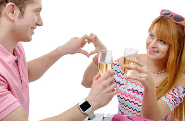 Happy young couple drinking glass of champagne