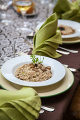 Risotto with wild mushrooms with parsley and parmesan on blue background