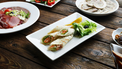 Crepes rolls filled with salted salmon.