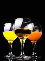 Citrus juice in a glass on a black background