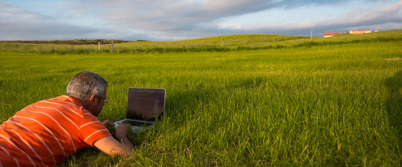 Man at work in the meadow at sunset