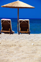 view of the beach with chairs and umbrellas