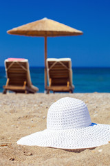 blue color of sea and hat on sand