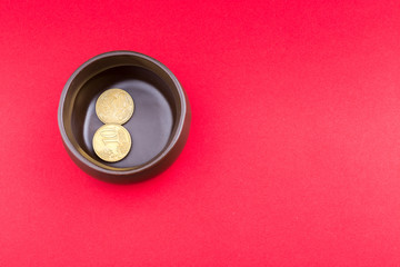 Brown pot on its side with few coins