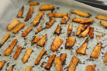 Baked sweet potato fries with olive oil, allspice and origano. Selective focus.