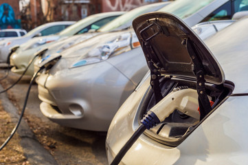 Electric cars charging at recharging station.