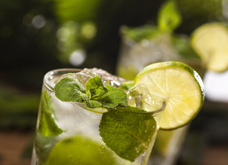 Mojito cocktail on tropical background
