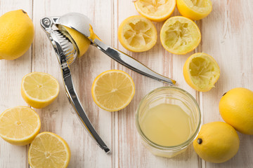 Lemon Press with Lemons and Juice in Glass