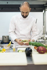 Male professional chef cooking in a kitchen.