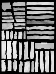 Piece of torn paper on black. Copy space