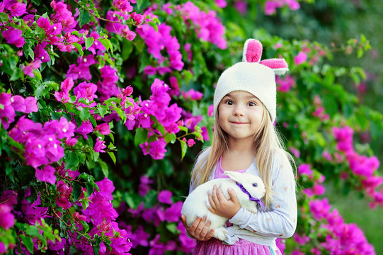 Cute happy girl with easter bunny