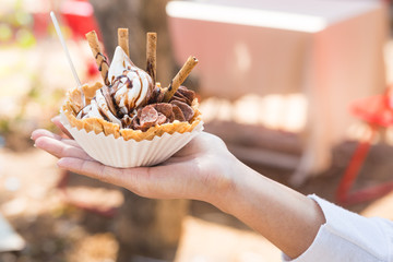 Closeup of ice cream held in hand by cute girl