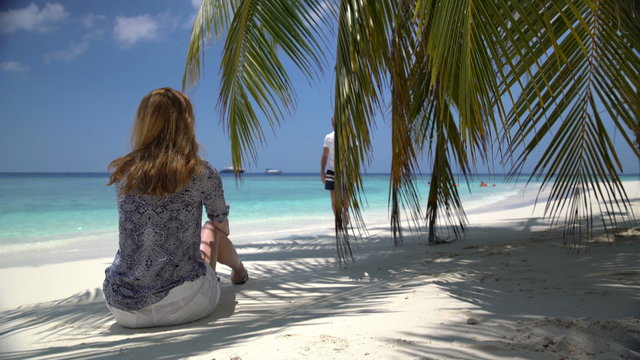 The date on the ocean. An attractive young woman and a handsome man enjoying a holiday on the tropical coast.