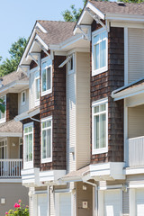 Custom built townhouses in a residential neighborhood in North America on a sunny day.