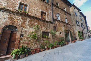 Fototapeta na wymiar Narrow street in historical village Pienza, Tuscany, Italy