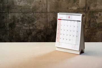 June Calendar 2016 and old flower on wood table