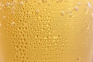 Closeup Orange beer and white froth background.