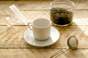 Tea set on the wooden table at sunny morning