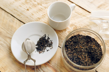 Tea set on the wooden table at sunny morning