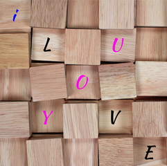 wood background : message I love you spelled in wooden block
