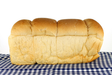loaf of bread on tablecloth