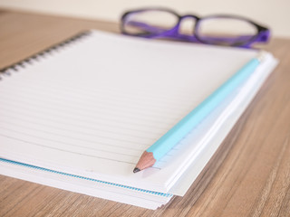 Blank paper and pencil on the wooden table