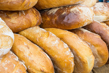 Freshly baked traditional loaves of rye bread on stall