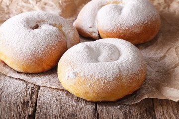 Spanish ensaimadas sweet rolls with powdered sugar close-up 
