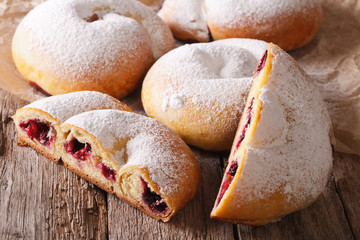 Sliced bun ensaimadas with berry filling close-up on the table. Horizontal
