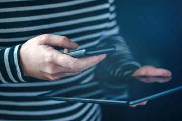Smartphone and tablet data synchronization, woman syncing files