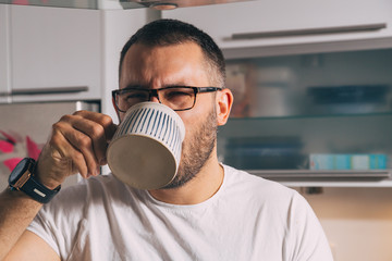 man drinking coffee from mug