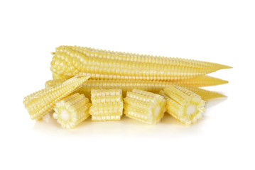 whole and cut baby corn on white background