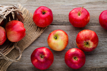 Ripe red apples on wooden background.