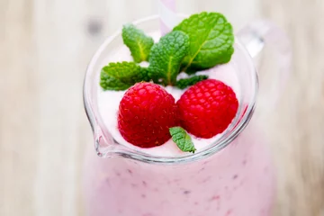 Fotobehang Milkshake Raspberry milk shake with mint decor.