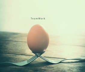 Egg on the fork with text teamwork business concept in vintage t