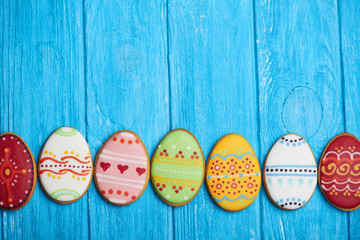 Colorful easter cookies on blue wooden background
