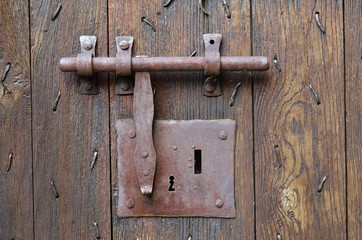 Old-style lock with a hasp on the timber entrance