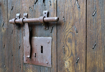 Old-style lock with a hasp on the timber entrance