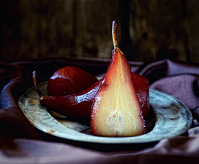 pears in red wine on a vintage plate and wood background   © venge
