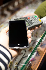 Woman pay with mobile phone by NFC
