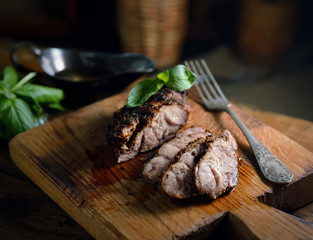 grilled meat, basil on a wooden background